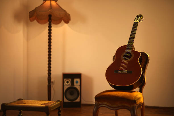 istock Acoustic guitar in a retro vintage room. 1324355281