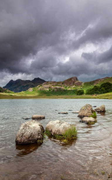 istock Lake District Blea Tarn With Rocks In Foreground & Dramatic Sky 1324355348