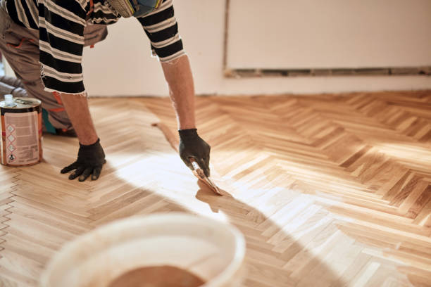istock Repairman restoring old parquet hardwood floor. 1324355608