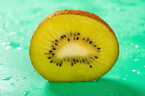 fresh kiwi fruit section on a green background
