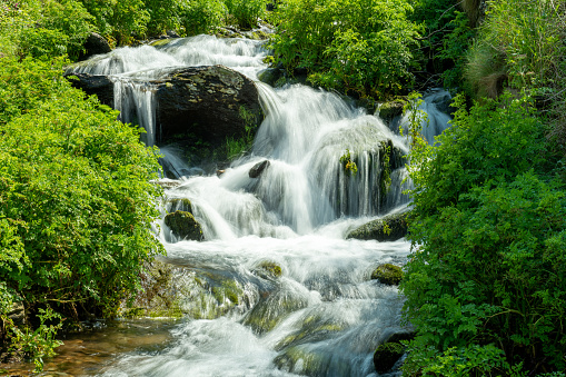 Long exposure of a waterfall flowing onto Lee Abbey Beach in Devon