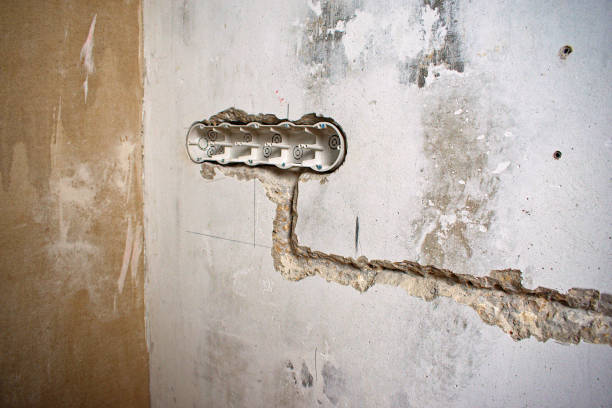 electrical installation. strobes in the wall for wires and a socket box for sockets in the wall. apartment renovation concept. - electrical junction box imagens e fotografias de stock