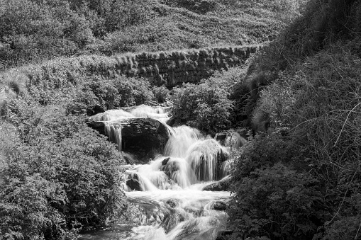 Long exposure of a waterfall flowing onto Lee Abbey Beach in Devon