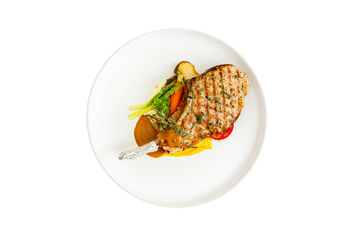 Top view of pork chops steak with vegetable and sauce isolated on white background.clipping path
