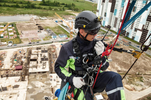 Industrial mountaineering worker in uniform with walkie-talkie