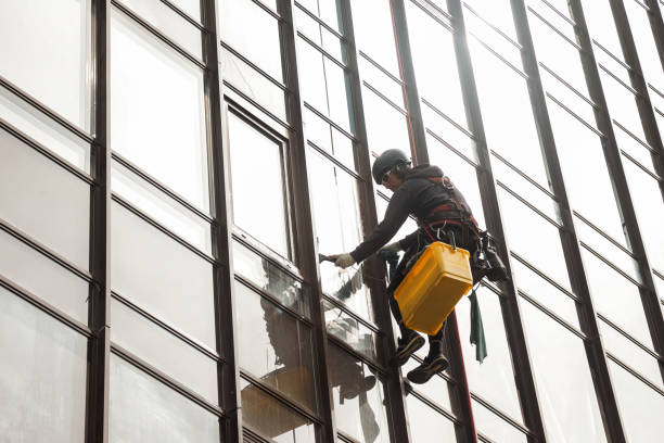 istock Industrial mountaineering worker hangs over residential facade 1324364082
