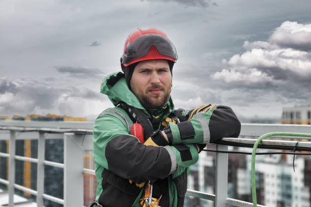 istock Portrait industrial mountaineering worker in uniform on roof 1324364090