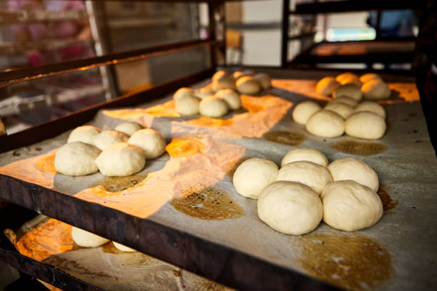 istock Raw dough bread on a oven-tray before baking in an oven at the manufacturing 1324364861