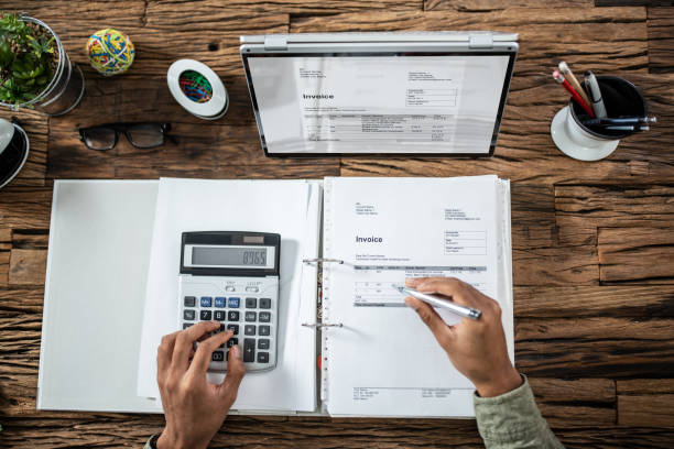 istock Businessman's Hands Working On Invoice On Laptop 1324367622