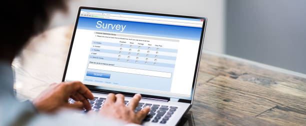 Online Survey Form. Man Filling List Online Survey Form. Man Filling List On Laptop Computer surveyor photos stock pictures, royalty-free photos & images