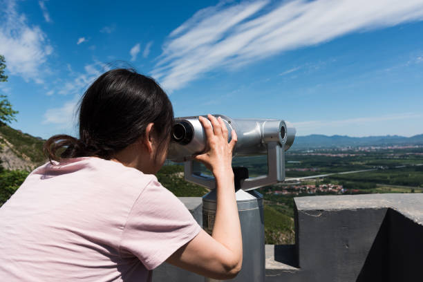 istock An Asian woman watching natural scenery with binoculars 1324369609