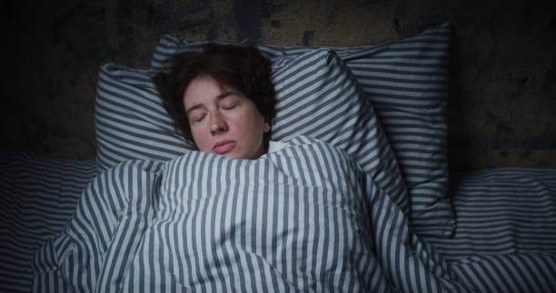 istock Mature woman is sleeping in bed 1324369904