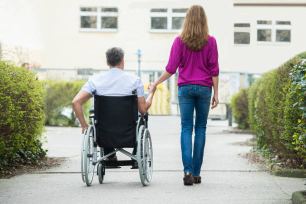 istock Woman With Her Disabled Husband 1324371329