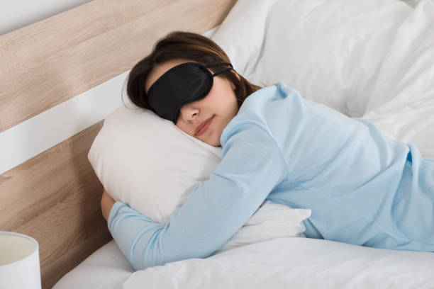 istock Woman Sleeping With Eyemask On Bed 1324371370