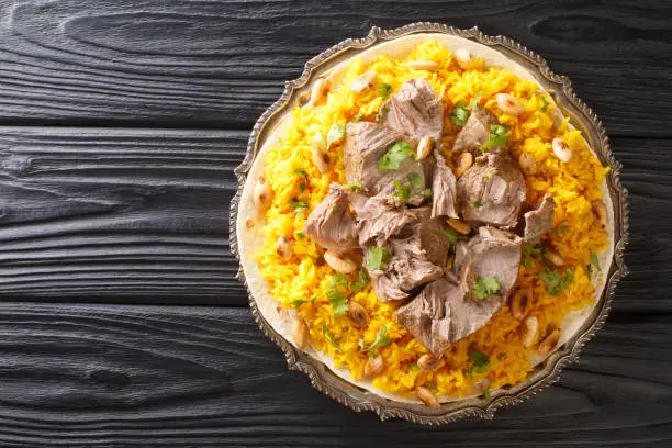 National favorite in Jordan mansaf is an offshoot of traditional Bedouin cuisine that makes for a delightful communal meal closeup in the plate on the table. Horizontal top view from above