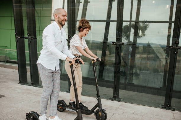 istock Two friends are commuting on electric scooter and having fun 1324373313