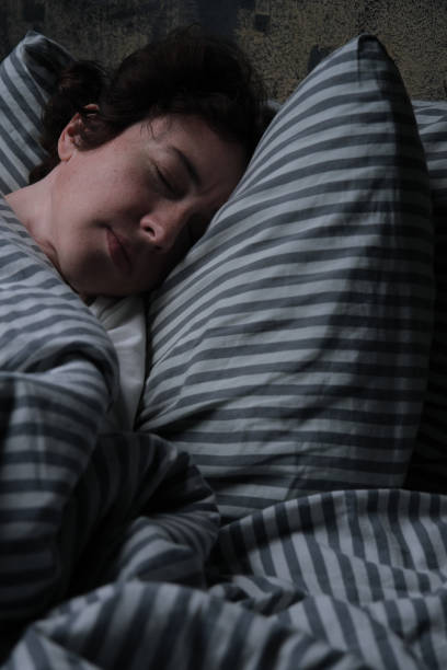 istock Mature woman is sleeping in bed 1324373337