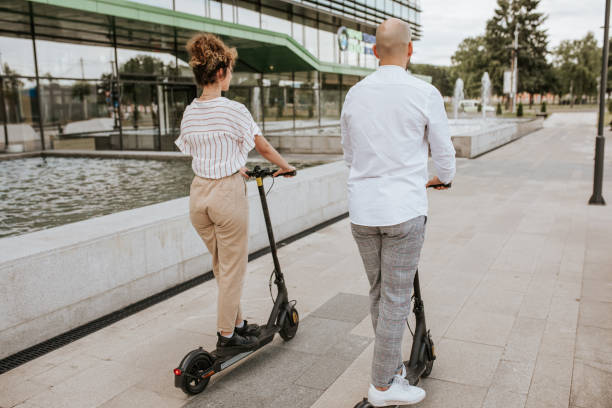 istock Two friends are commuting on electric scooter 1324373343