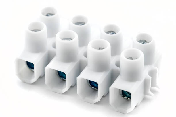 Plastic connection block with 4 entries for strands and solid conductors for electric cables, isolated on white background.