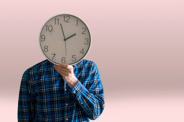 istock time management concept, employee person holding a clock 1324375559