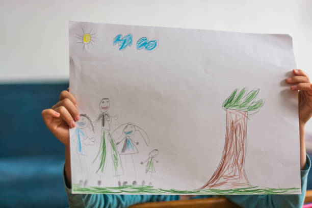 istock Unrecognizable child holding her drawing on a paper 1324375679