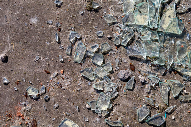 broken glass lies on the concrete floor, close-up stock photo