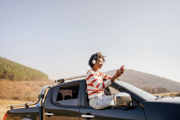 istock Young woman having a video call while on a road trip 1324377974