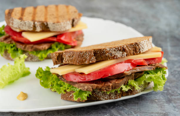 istock Toasted bread on a plate with beef, tomatoes, cheese and lettuce 1324377986