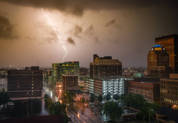 Dayton Ohio Thunderstorm A dramatic and storm lighting storm struck Dayton Ohio's downtown district on June 19th, 2021. The setting sun tinted the storm with an dusky orange color. dayton ohio skyline stock pictures, royalty-free photos & images
