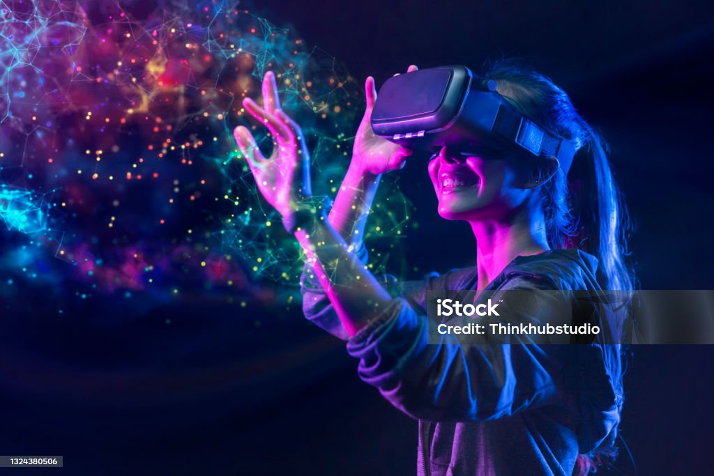 People with VR grasses playing virtual reality game. Future digital technology and 3D virtual reality simulation modern futuristic lifestyle Virtual Reality Simulator Stock Photo