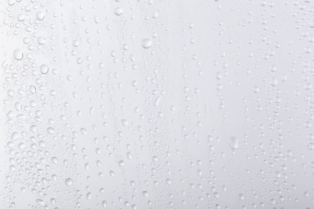 istock water droplets on white glass. 1324382851