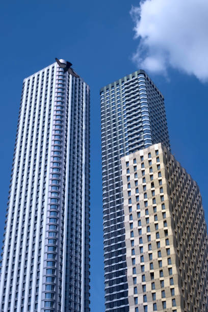 istock Two modern tall buildings, skyscrapers in the blue sky. 1324383036