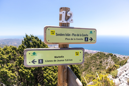 Guide signs for the tourist route to climb La Concha mountain in Marbella.