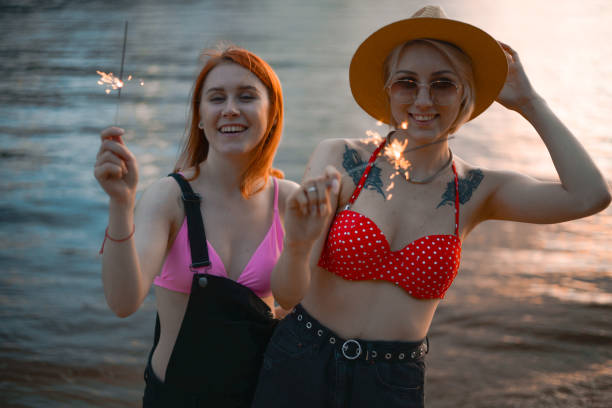istock Two LGBTQIA+ lesbian folks having fun in summer at sunset 1324392812