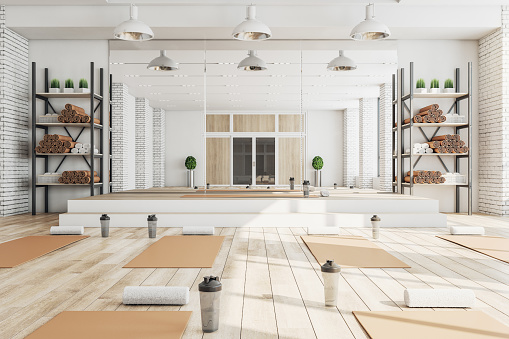 Nuevo interior de gimnasio de yoga de hormigón con equipamiento, luz natural y suelo de madera. Concepto de estilo de vida saludable. Renderizado 3D. photo