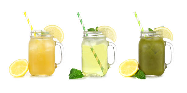 Set of summer iced green teas in mason jar glasses isolated on white Set of summer iced green teas in mason jar glasses isolated on a white background. Iced green tea lemonade, iced green tea and iced matcha lemonade. mason jar lemonade stock pictures, royalty-free photos & images