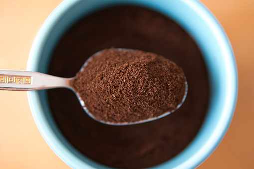 Organic ground coffee on a spoon