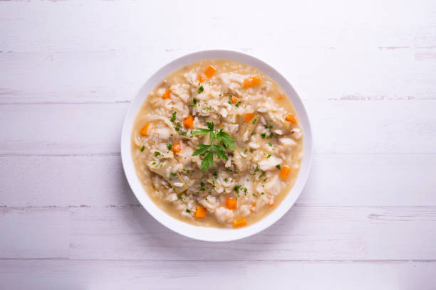istock Soupy rice with cod, carrot and artichokes. Traditional Spanish tapa. 1324406697