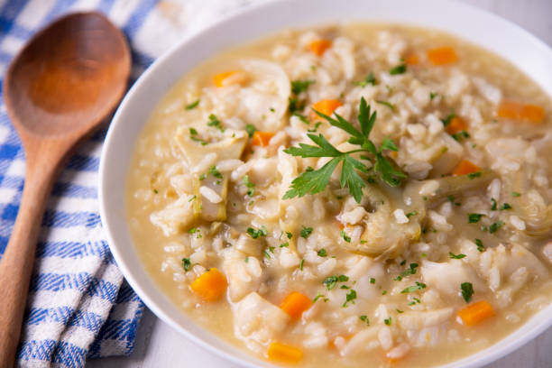 istock Soupy rice with cod, carrot and artichokes. Traditional Spanish tapa. 1324406718