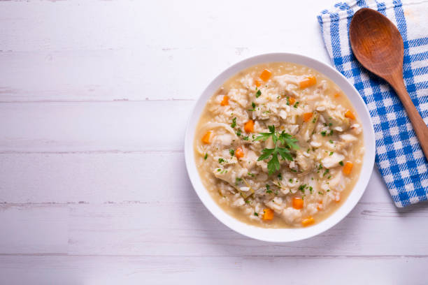 istock Soupy rice with cod, carrot and artichokes. Traditional Spanish tapa. 1324406723