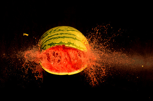Broken watermelon on black background