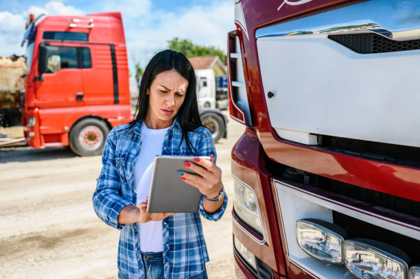 istock Female truck driver using a mobile app 1324413230