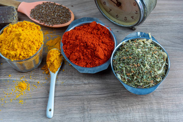 istock Colorful culinary spices and clock on wooden surface. 1324414702