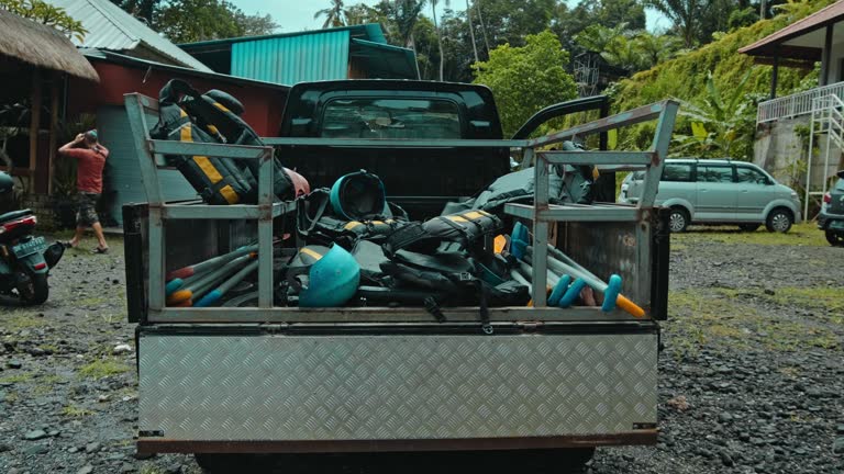 protective jackets with yellow lines and protective helmets to practice rafting lying in the trunk