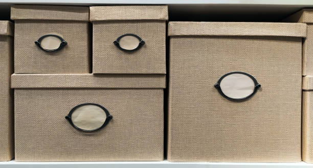 Beige wicker boxes with lids and place for signature. Boxes for moving or storing various little things.