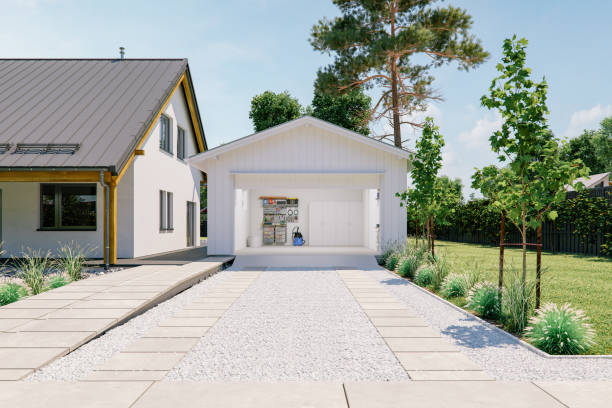 Open Garage With Concrete Driveway Open door of a modern garage with a concrete driveway at the urban district. empty home garage stock pictures, royalty-free photos & images