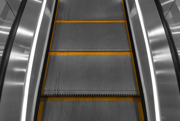 istock Gray escalator steps with orange lines close-up. Stopped escalator. 1324420479