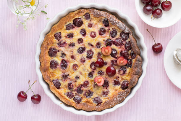 Cherry clafoutis Cherry clafoutis on pink background clafoutis stock pictures, royalty-free photos & images