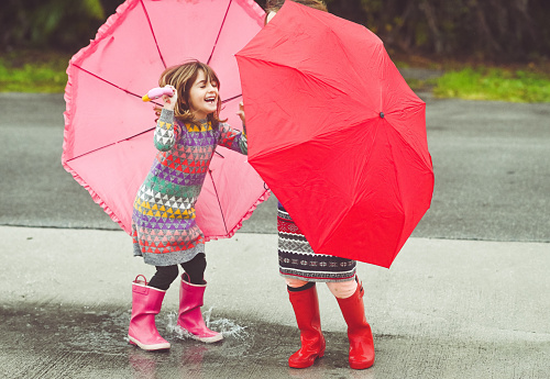Kids outdoors with umbrellas