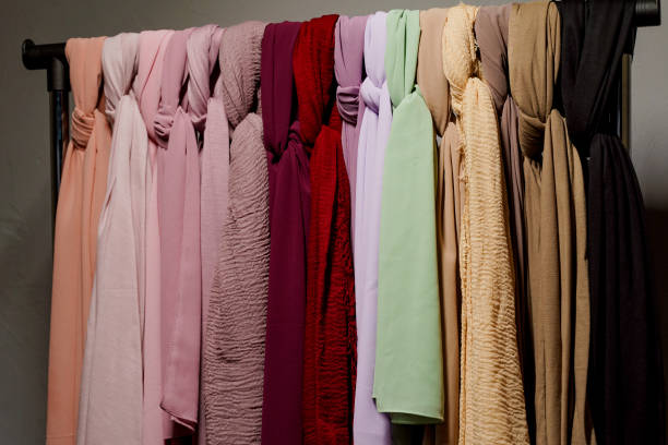 istock Silk scarf muslim. Multi-colored plain scarves on hanger. 1324426325